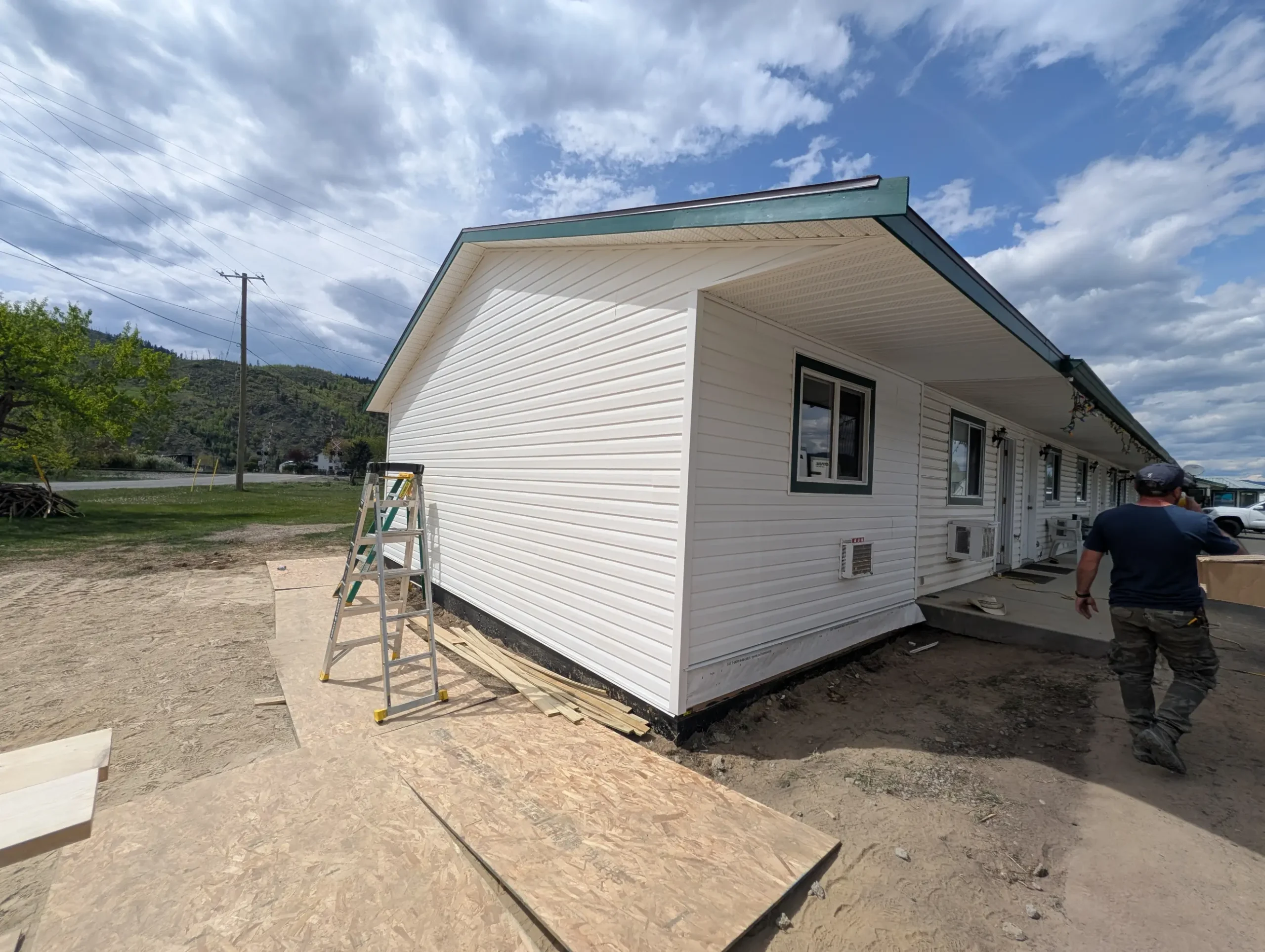 Concrete walkway beside a white sided building