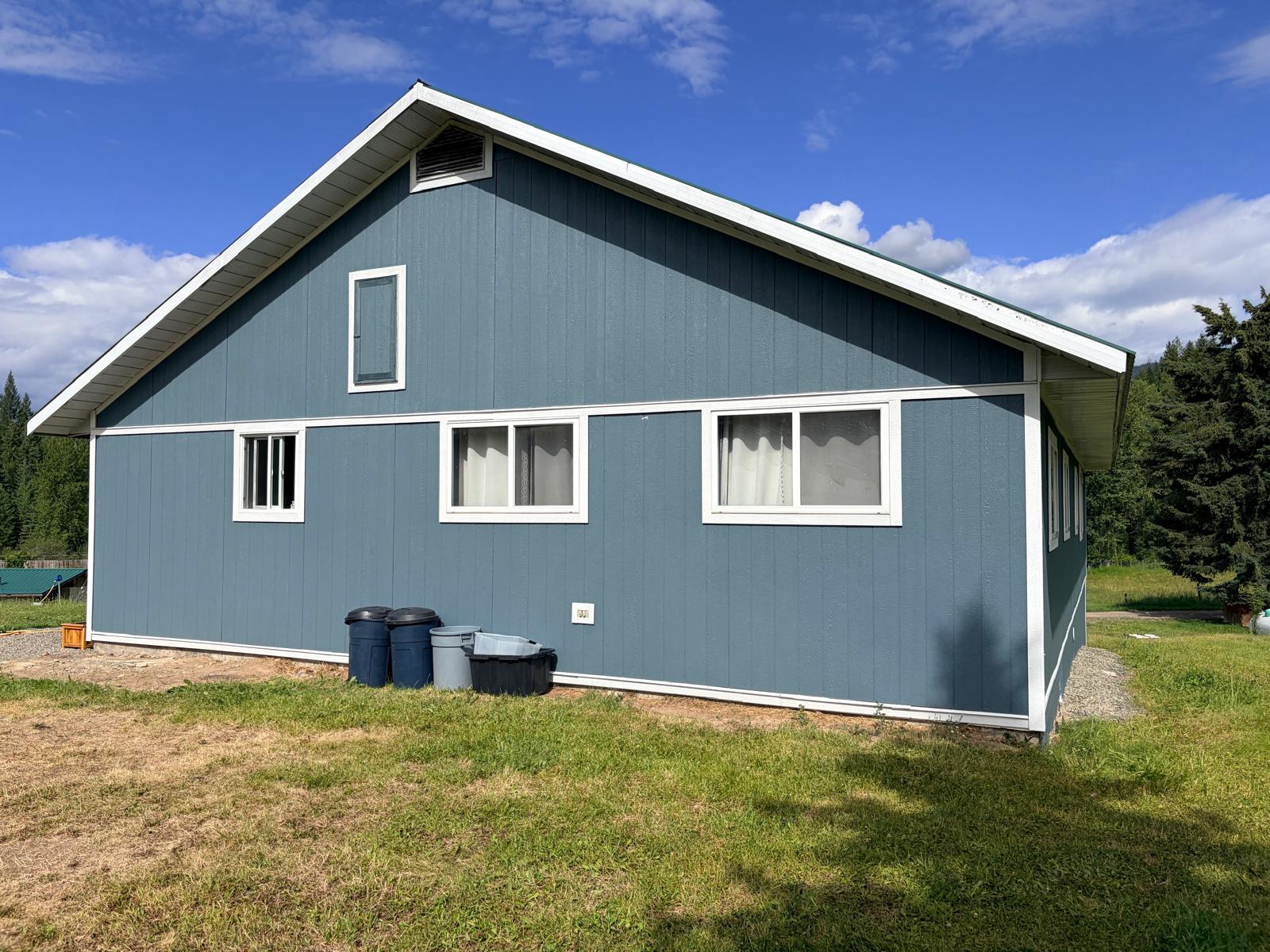 Blue exterior siding and metal roofing on a building