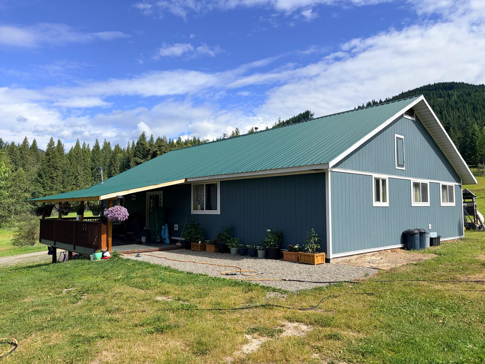 Exterior of a blue building with a green metal roof
