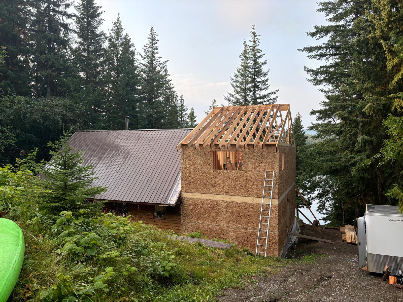 Cabin addition during wall sheathing and roof framing
